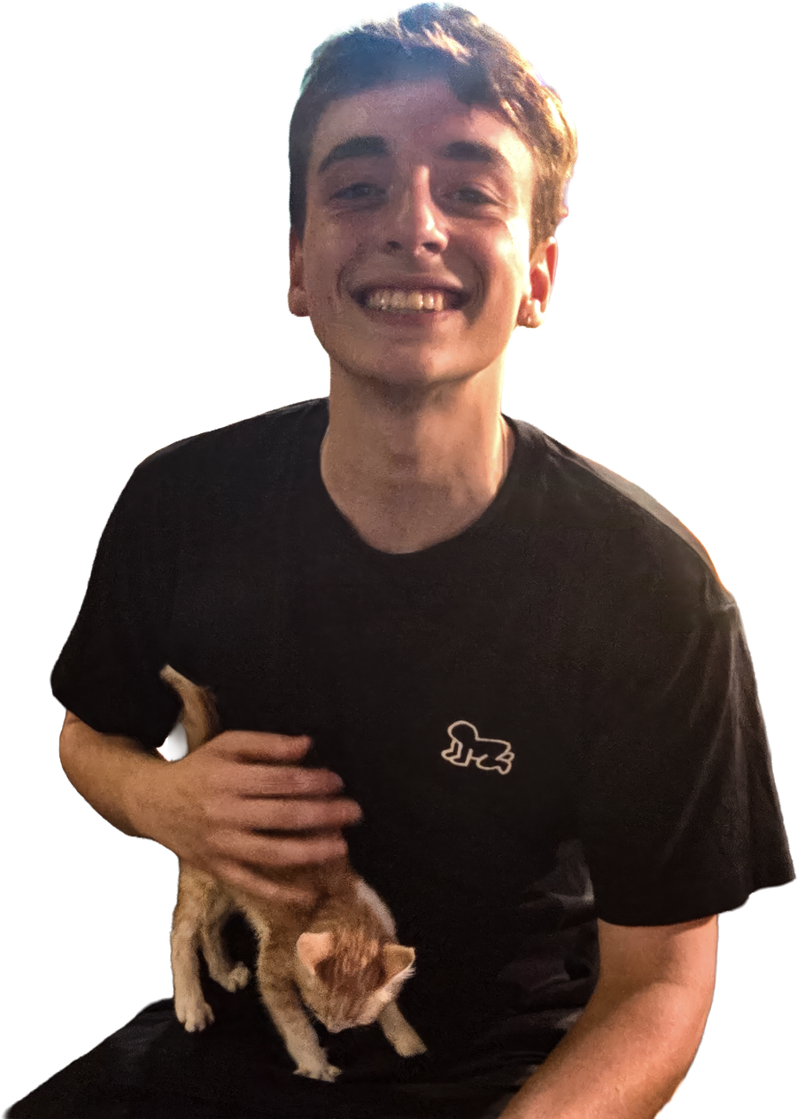 Jack Whitehead smiling and holding a friend's kitten