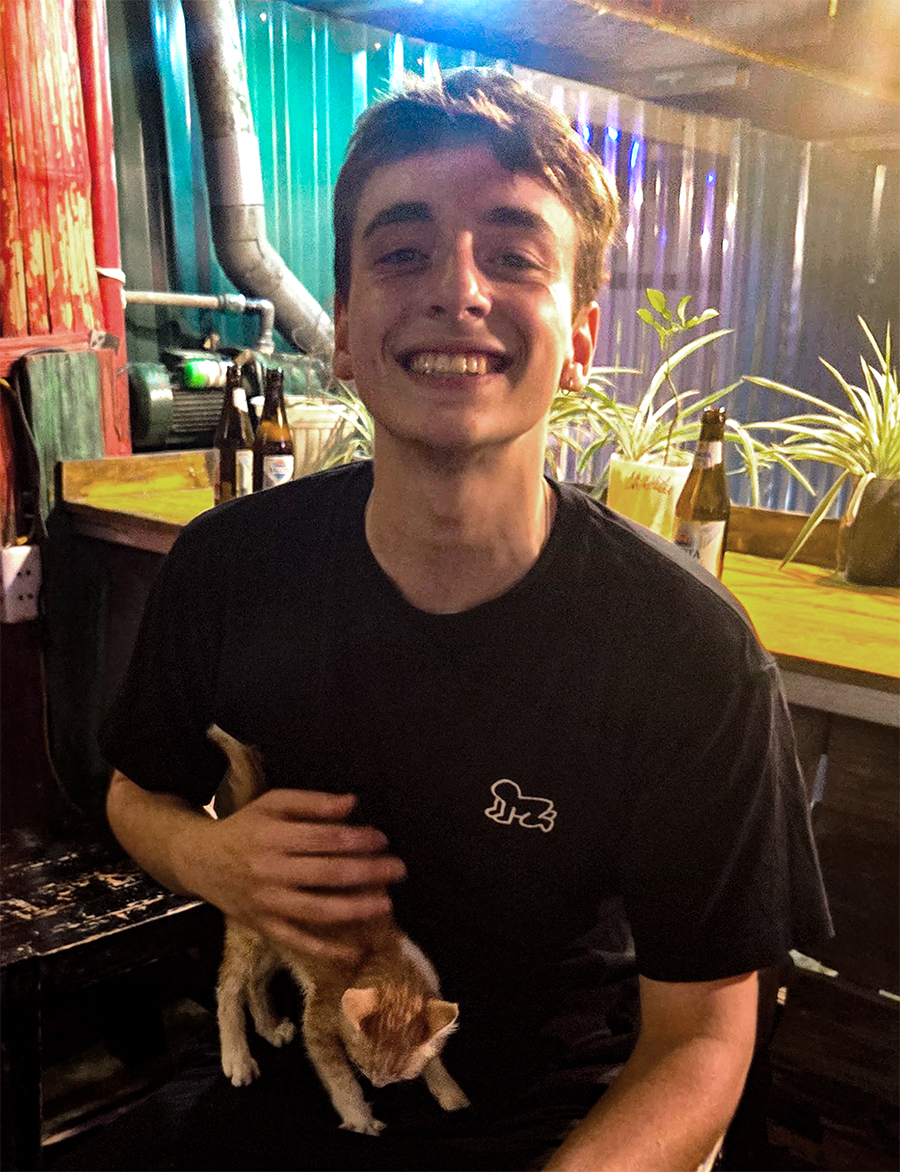 Jack Whitehead smiling and holding a friend's kitten